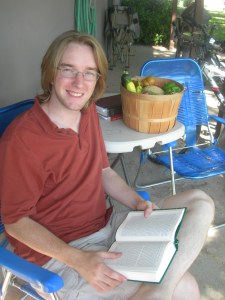 hubby reading on the porch